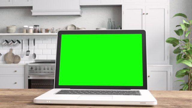 Laptop with Green Screen On Table With Kitchen Backgrounds
