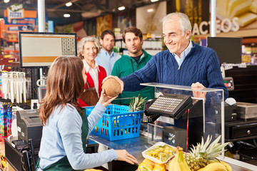 Customer paying at the supermarket cashier