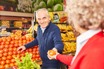 Seniors buy vegetables in the supermarket