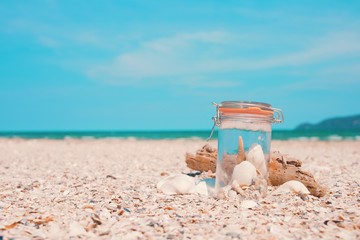 Fototapeta na wymiar Shells in the bottle on the beach.