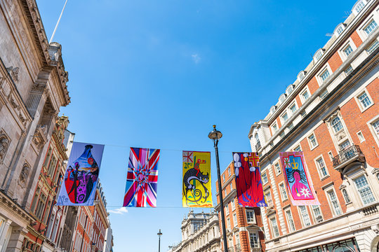 London, UK - June 22, 2018: Piccadilly circus street road with royal academy of arts exhibit banners against blue sky and historic architecture on sunny day