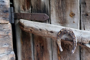 Nailed horseshoe - details of the wooden door of shepherd's hut in mountains on the route from the Mt. Megruki peak to Atskuri. Borjomi-Kharagauli National Park, Georgia. 