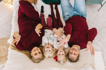 We stay at home! Social media campaign and coronavirus prevention: family smiling and staying together. Happy family with two kids at home together