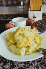 preparing the ingredients for a Spanish potato omelette with egg, onion and oil.