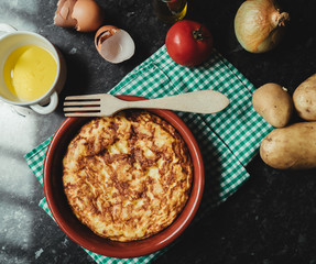 Homemade Spanish omelette with fresh ingredients from organic garden, typical Spanish food. Photo from above.