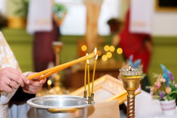 The priest lights candles in the Orthodox Church