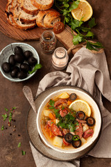 Traditional meat Russian soup solyanka on wooden background