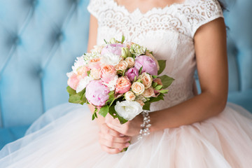 Beautiful wedding bouquet in the hands of the bride