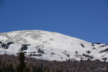 Snowy mountain top against the blue sky
