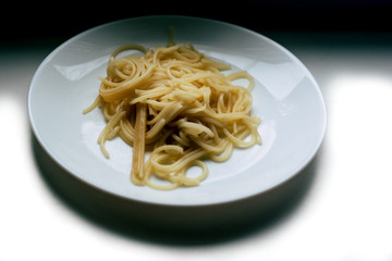 Pasta in a plate on a white background
