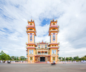Fototapeta na wymiar Cao Dai temple area and meditating followers of the Cao Dai religion in the temple Cao Dai, Tay Ninh, Vietnam