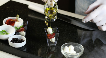 Chef preparing canapes in the kitchen at the restaurant 