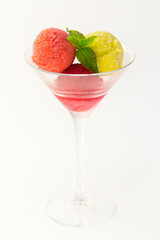 Sorbet, balls of ice cream in a glass glass on a white background.
