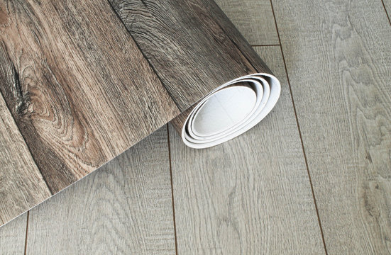 Roll of linoleum with a wood texture. Types of floor coverings. 