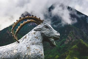 Statue of a mountain goat on the background of mountain range in the Ongudaysky district of the...