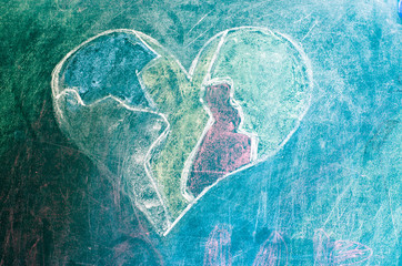 Heart drawn on a green blackboard. Drawing heart close-up.