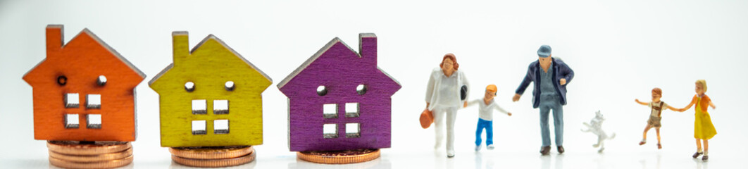 Miniature people: Group of couple and father, Mother, child standing with stack of coins using as background Money, saving planing, financial, insurance, business growth and family concept.