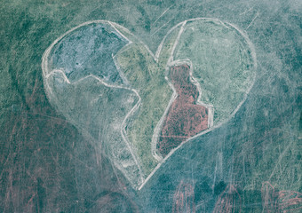 Heart drawn on a green blackboard. Drawing heart close-up.