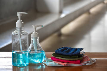 Hand sanitizer gel and facemasks in front of the office's doors for the officers to clean hands and wear before getting inside to protect and prevent Covid-19 virus or Coronavirus and germs.