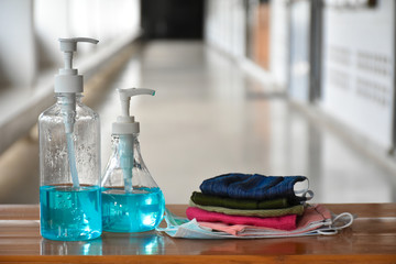 Hand sanitizer gel and facemasks in front of the office's doors for the officers to clean hands and wear before getting inside to protect and prevent Covid-19 virus or Coronavirus and germs.