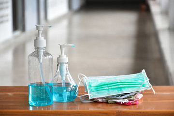 Hand sanitizer gel and facemasks in front of the office's doors for the officers to clean hands and wear before getting inside to protect and prevent Covid-19 virus or Coronavirus and germs.