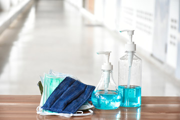 Hand sanitizer gel and facemasks in front of the office's doors for the officers to clean hands and wear before getting inside to protect and prevent Covid-19 virus or Coronavirus and germs.