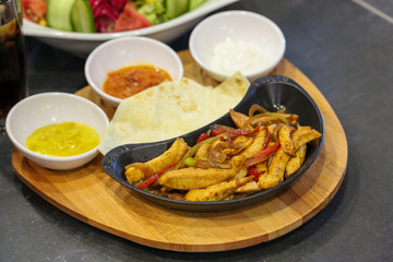 fried chicken with vegetables in pan