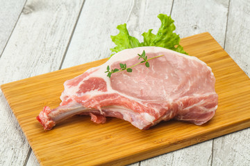 Raw pork bone steak over wooden