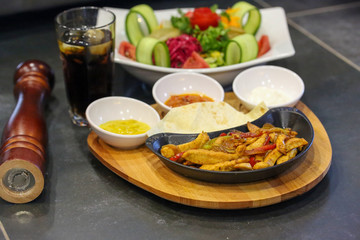 fried chicken with vegetables in pan
