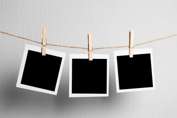 polaroid frame.Retro photo frames hanging on rope isolated on white background. real photo