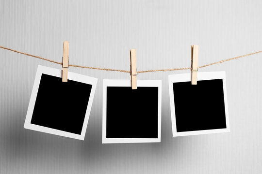 polaroid frame.Retro photo frames hanging on rope isolated on white background. real photo