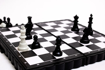 Captured king of chess on white background