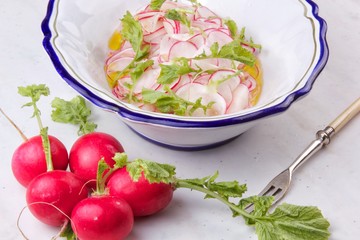 Simple spring salad of sliced radishes in plate