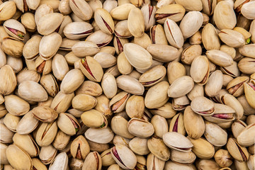 Heap of pistachio nuts as a background