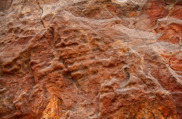 The textured surface of red limestone.