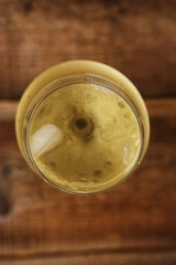 A glass of white wine on a wooden table