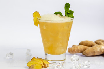 Fresh homemade ginger beer cocktail. Ice and lime on the table. On white background. Copy space.