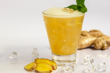 Fresh homemade ginger beer cocktail. Ice and lime on the table. On white background. Copy space.