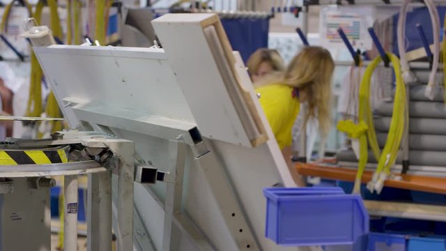 female tacholovyks collect a car cable on a rolling stand