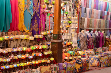 Traditional Turkish Lamps / lanterns, Ottoman Lights, Mosaic Chandeliers, pillow / cushion covers, kaftan, salwar kameez on display in a handicraft pawn shop in Dubai, UAE during Ramadan month.