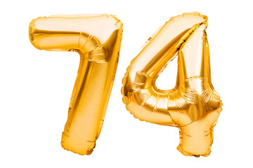 Number 74 seventy four made of golden inflatable balloons isolated on white. Helium balloons, gold foil numbers. Party decoration, anniversary sign for holidays, celebration, birthday, carnival