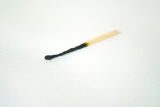 Close Up Of Burnt Match Stick On Table