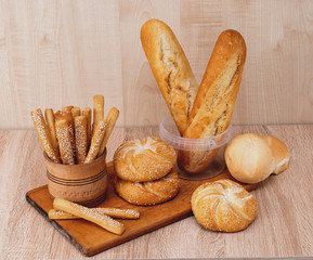Сrisp bread with buns. French baguettes. Fresh crispbread. Bread background. Different breed  on...