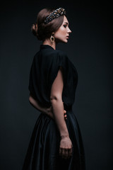 Fashion portrait.  Girl in a black blouse with a tiara on her head. © Alexander Seluyanov