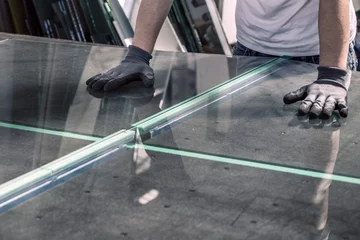 Deurstickers glazier breaking glass on a professional table © Rochu_2008