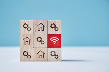 Online distance working. Work from home. Stay home. Square of wooden cubes with house sign. Red block with wifi symbol