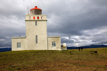 Fototapeta na wymiar Vik / Iceland - August 15, 2017: Dyrholaey promontory lighthouse, Vik, Iceland, Europe
