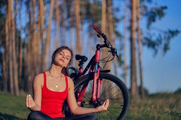 Meditation in nature. The girl came by bicycle to the edge of the forest.