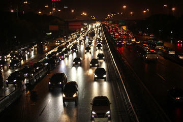 Fototapeta na wymiar Traffic in the night after the rain in Beijing