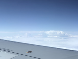 view from window on the wing of an airplane and the endless sky